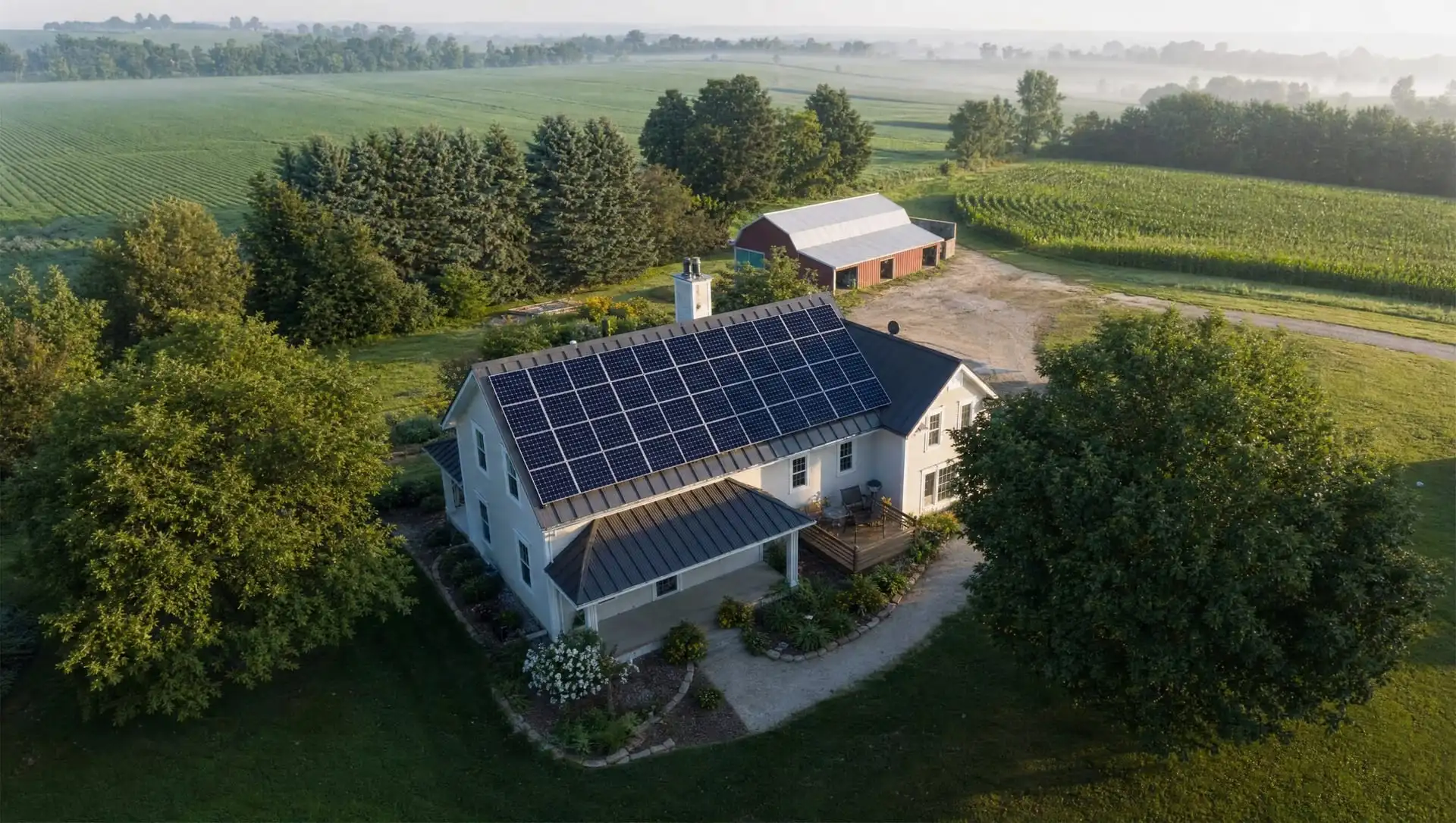 Aerial view of a rural home with a rooftop solar array